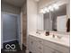 Spacious bathroom featuring double sinks, ample counter space, and a walk-in closet at 8866 Twain Ln, Indianapolis, IN 46239