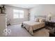 Serene bedroom with natural light, neutral decor, and comfortable furnishings at 8866 Twain Ln, Indianapolis, IN 46239