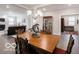 Elegant dining room with decorative chandelier and adjacent living area in a modern, open-concept home at 8866 Twain Ln, Indianapolis, IN 46239