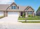 A charming home with a two-car garage, lush lawn, and appealing design elements at 8866 Twain Ln, Indianapolis, IN 46239
