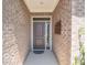 A cozy front entryway with a modern door and brick accents, creating a welcoming ambiance at 8866 Twain Ln, Indianapolis, IN 46239