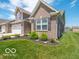 Brick-accented townhome featuring manicured landscaping, adding to its curb appeal at 8866 Twain Ln, Indianapolis, IN 46239