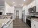 Bright kitchen showcases stainless steel appliances, white cabinets, and granite countertops at 8866 Twain Ln, Indianapolis, IN 46239