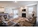 Spacious living room featuring a fireplace, TV, recessed lighting, and an open layout to the adjacent kitchen and dining areas at 8866 Twain Ln, Indianapolis, IN 46239