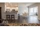Modern living space with a breakfast bar that opens to the kitchen and is connected to an airy dining room area at 8866 Twain Ln, Indianapolis, IN 46239
