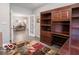 Office space with custom built-ins, offering ample storage and a view into the connected dining area at 8866 Twain Ln, Indianapolis, IN 46239