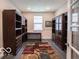 Well-lit home office with custom shelving, desk, and comfortable layout, offering a great work-from-home space at 8866 Twain Ln, Indianapolis, IN 46239