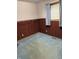 Bedroom featuring wood-paneled walls, carpet, and a window with curtains at 8923 Maze Rd, Indianapolis, IN 46259