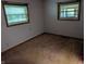 Empty bedroom featuring two windows, carpeted floors, and neutral walls at 8923 Maze Rd, Indianapolis, IN 46259