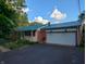 A well-maintained single-story home featuring a blue metal roof and a two-car attached garage at 8923 Maze Rd, Indianapolis, IN 46259