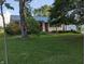 A single-story home with a well-manicured lawn and mature trees under a sunny sky at 8923 Maze Rd, Indianapolis, IN 46259