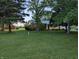 Charming single-story home with a well-manicured lawn and mature trees providing a peaceful setting at 8923 Maze Rd, Indianapolis, IN 46259