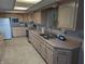 Spacious kitchen with stainless steel appliances, light wood cabinets, and a double sink at 8923 Maze Rd, Indianapolis, IN 46259