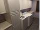 Functional laundry room with ample cabinet space, countertops, and a washing machine at 8923 Maze Rd, Indianapolis, IN 46259