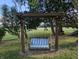 Inviting porch swing hanging from a wooden pergola offering a peaceful spot to relax outdoors at 8923 Maze Rd, Indianapolis, IN 46259