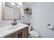 Modern half-bathroom featuring a new vanity, light fixture and decorative shelf at 901 Mallory Pkwy, Franklin, IN 46131
