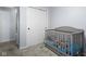 Cozy Bedroom featuring a gray crib and a closet with sliding doors at 901 Mallory Pkwy, Franklin, IN 46131