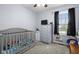 Neutral-toned Bedroom with gray crib, dresser, and window view at 901 Mallory Pkwy, Franklin, IN 46131