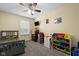 Cheerful bedroom with ceiling fan, window, carpet, and wall decorations and storage at 901 Mallory Pkwy, Franklin, IN 46131