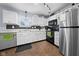 A galley kitchen features white cabinets and black appliances at 901 Mallory Pkwy, Franklin, IN 46131