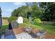 Spacious backyard featuring a wood deck with seating, outdoor grill, storage shed and a playset at 911 Glendale Dr, Lebanon, IN 46052