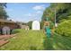 Lush backyard with a shed, playset, outdoor grill and ample green space at 911 Glendale Dr, Lebanon, IN 46052