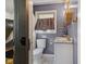 Stylish bathroom featuring modern fixtures, a window above the toilet and neutral walls at 911 Glendale Dr, Lebanon, IN 46052