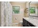 Bathroom featuring a single sink vanity, marble countertop, tile floor and modern fixtures at 911 Glendale Dr, Lebanon, IN 46052