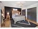 Charming bedroom features black accent wall, rustic wood bed frame, stylish rug and natural light at 911 Glendale Dr, Lebanon, IN 46052