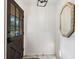 Bright entryway with a dark front door, vintage mirror and neutral walls at 911 Glendale Dr, Lebanon, IN 46052