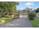 Well maintained home with a large tree in the front yard and driveway at 911 Glendale Dr, Lebanon, IN 46052