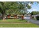 Charming brick and vinyl home featuring a basketball hoop above a two-car garage at 911 Glendale Dr, Lebanon, IN 46052