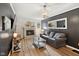 Inviting living room featuring a brick fireplace and hardwood flooring, perfect for relaxation at 911 Glendale Dr, Lebanon, IN 46052