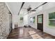 Sunroom features hardwood floors, exposed ceiling beams, a brick wall and lots of natural light at 911 Glendale Dr, Lebanon, IN 46052
