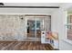 Sunroom features hardwood floors, a brick wall, sliding glass doors and playset at 911 Glendale Dr, Lebanon, IN 46052