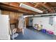 View of the unfinished basement with wood paneled walls and exposed beams at 95 S 11Th Ave, Beech Grove, IN 46107