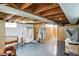 Unfinished basement with exposed beams, wood paneled walls, and concrete flooring at 95 S 11Th Ave, Beech Grove, IN 46107