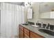 Bathroom featuring a double sink vanity, mirrors, and shower with curtain at 95 S 11Th Ave, Beech Grove, IN 46107