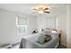 Cozy bedroom with a ceiling fan and natural light from the window at 95 S 11Th Ave, Beech Grove, IN 46107