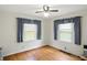 Bright bedroom with hardwood floors, and natural light from dual windows with curtains at 95 S 11Th Ave, Beech Grove, IN 46107