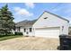 Charming home featuring a spacious two-car garage and well-maintained front lawn at 95 S 11Th Ave, Beech Grove, IN 46107