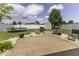 Spacious backyard featuring a patio, trampoline, storage shed and surrounded by a white fence at 9628 Gull Lake Dr, Indianapolis, IN 46239