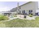 Wide backyard featuring a patio, landscaping, white fence, and a grill at 9628 Gull Lake Dr, Indianapolis, IN 46239