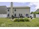 Large backyard with a patio, garden area, grill, and a privacy fence at 9628 Gull Lake Dr, Indianapolis, IN 46239