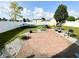 Spacious backyard features a large patio, lush lawn, trampoline, storage shed, and white vinyl fencing at 9628 Gull Lake Dr, Indianapolis, IN 46239
