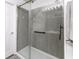Modern bathroom showcasing a tiled shower with glass doors and sleek fixtures at 9628 Gull Lake Dr, Indianapolis, IN 46239