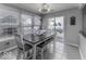 Bright dining room featuring a table set for six, tile floors, with sliding door access to the backyard at 9628 Gull Lake Dr, Indianapolis, IN 46239