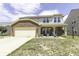 Charming two-story home featuring a brick facade, covered porch, well-kept lawn, and attached two-car garage at 9628 Gull Lake Dr, Indianapolis, IN 46239