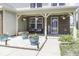 Inviting front porch with hanging flower baskets, potted plants, and seating area on decorative white stones at 9628 Gull Lake Dr, Indianapolis, IN 46239