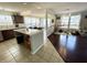 Open floor plan with a kitchen featuring an island and breakfast nook, leading to a living area or playroom at 9628 Gull Lake Dr, Indianapolis, IN 46239